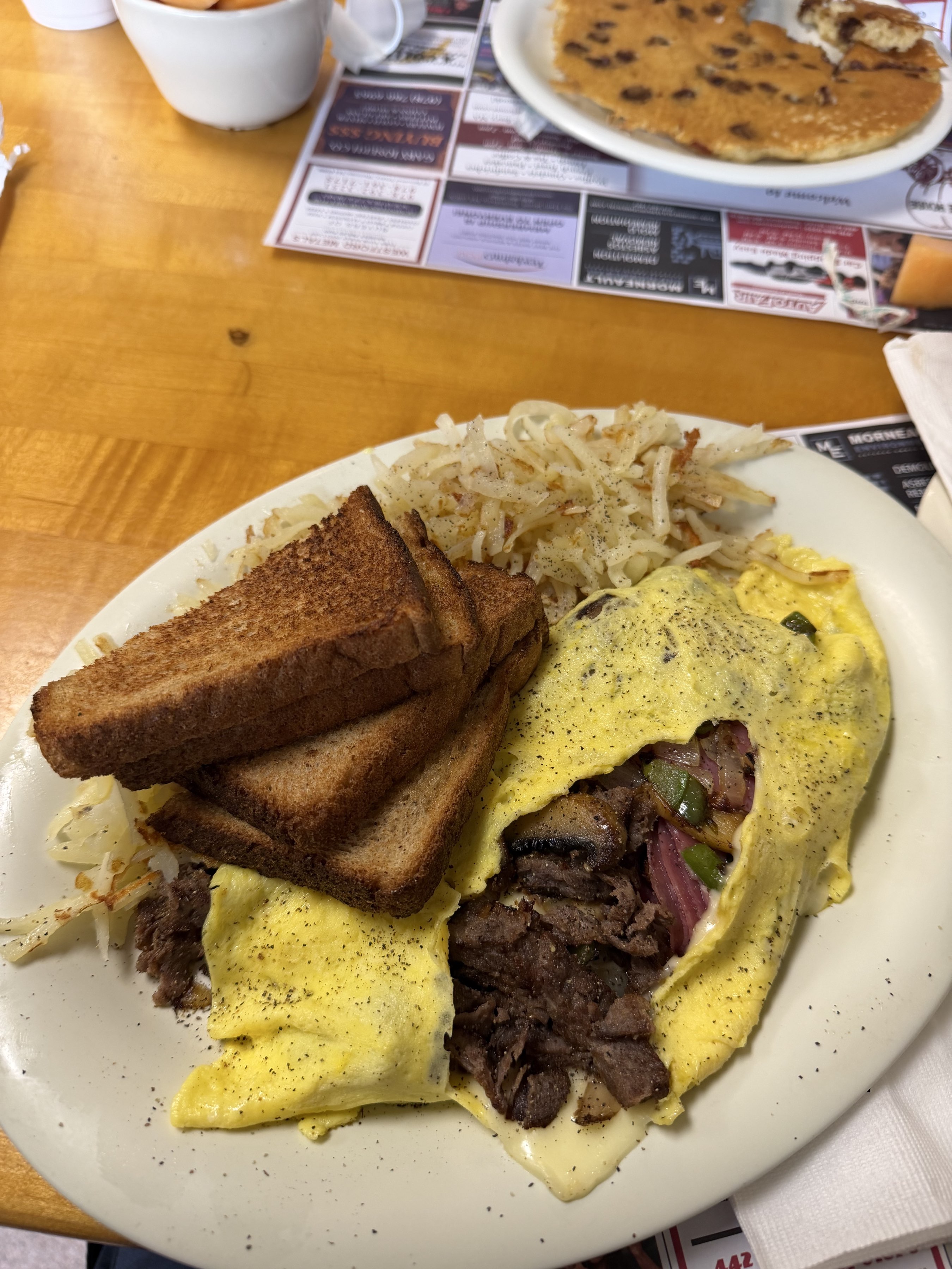 Steak bomb omelette, shredded hash browns, wheat toast